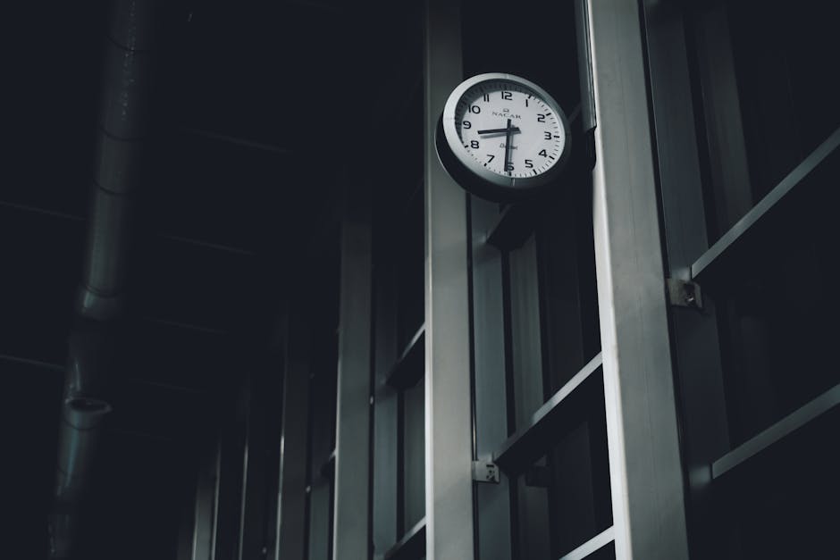 Abstract image featuring a clock against a dark modern metal interior, capturing a moody and minimalist atmosphere.