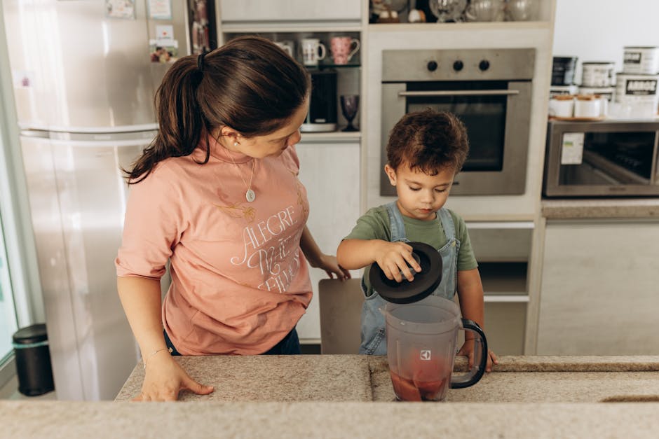 Mother and son bonding while preparing a smoothie in the kitchen.