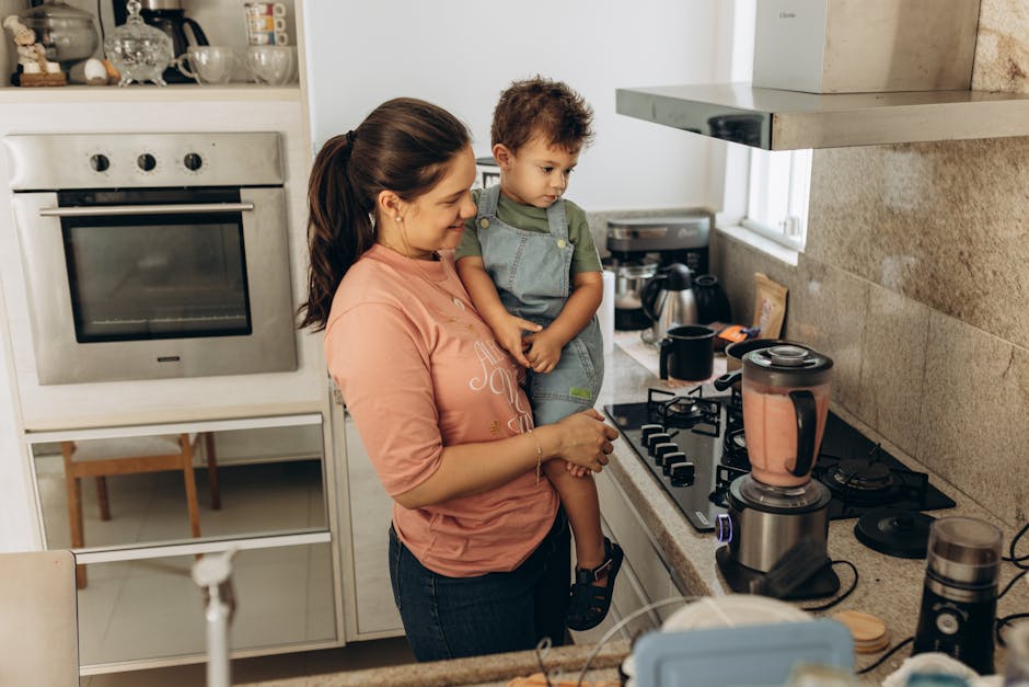 Mother and son enjoying smoothie preparation in a cozy kitchen setting.