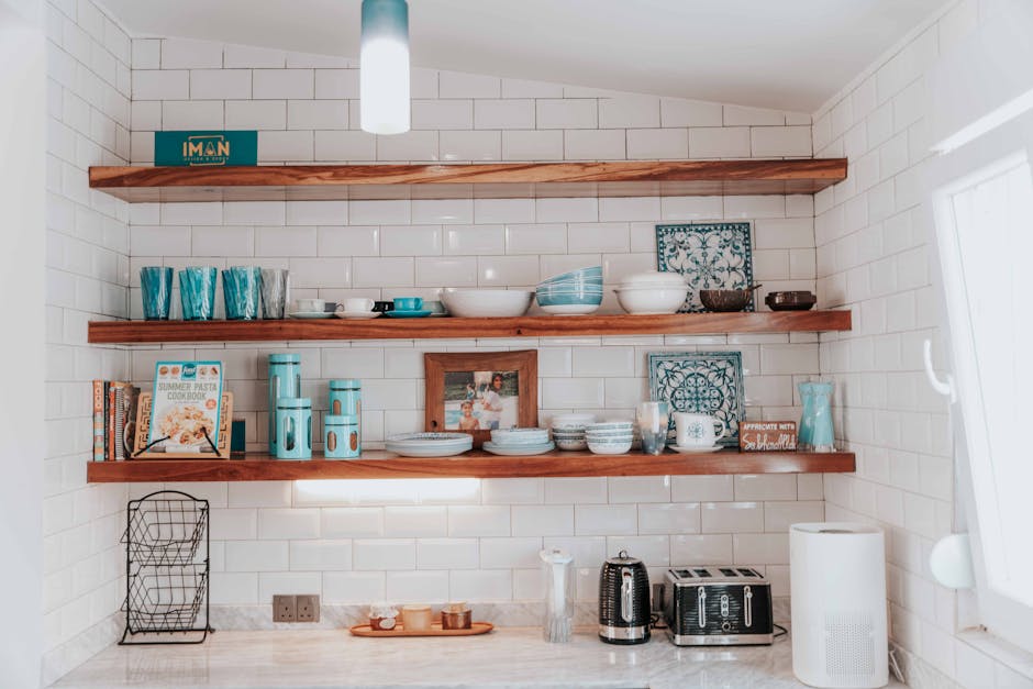 Stylish kitchen with open wooden shelves displaying tableware and decor.